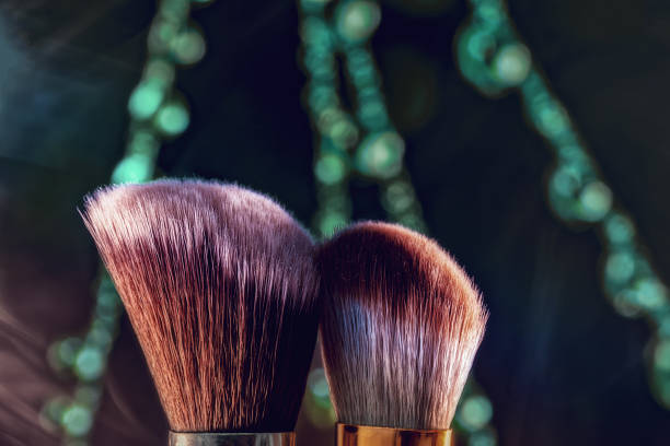 The makeup brush is photographed in close-up on a beautiful background , the concept of beauty and fashion