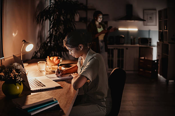 istock Mother and daughter enjoying a quiet evening at home while engaged in activities 2233415934