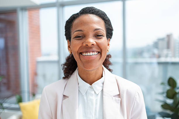 istock Smiling professional woman in modern office with natural light background 2233416315