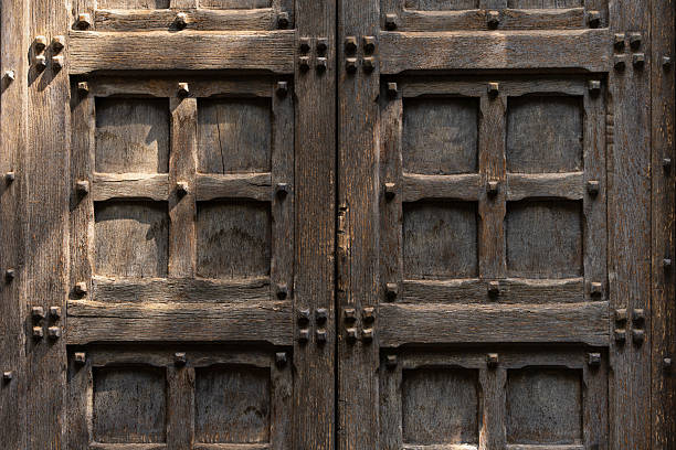 Wooden brown door with ancient square patten