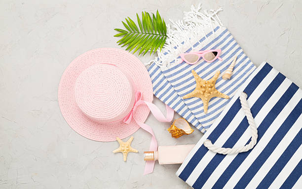 istock Blue beach bag with summer accessories on concrete background, top view 2233418566