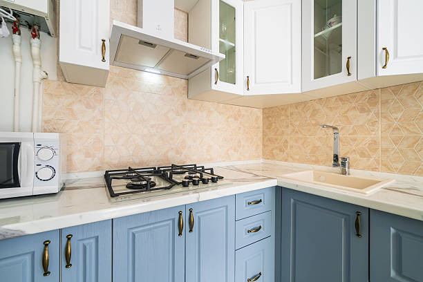 istock A kitchen with blue cabinets and white appliances 2233421845