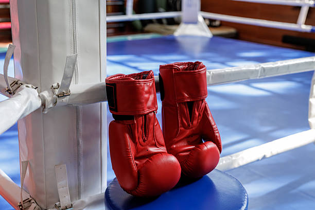 Blank red boxing gloves pair and single mockup, different views, 3d rendering. Empty sporting goods boxer hand protection mock up, isolated. Clear professional training uniform for fighting template.