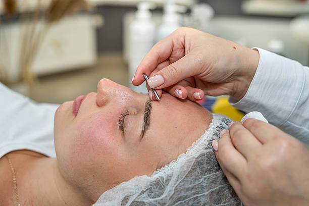 istock beautician doing manual face cleansing by young female client in beauty studio 2233423522