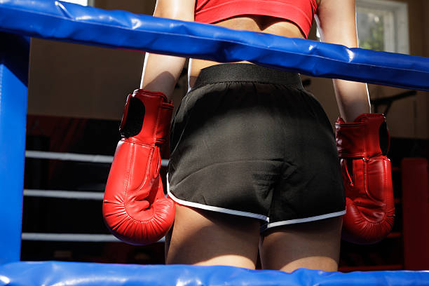 istock Boxer in ring with red gloves between rounds 2233427039