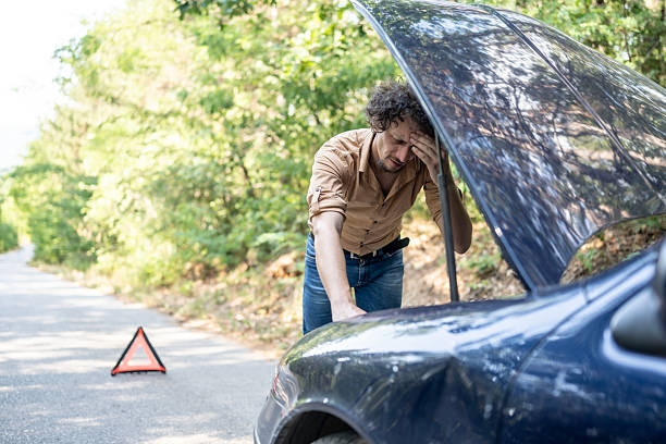 istock Frustrated Driver Fixing Car Breakdown in Remote Outdoor Area 2233430435