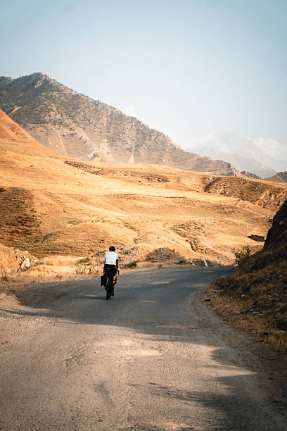 istock Bikepacker rides remote rural roads 2233432706