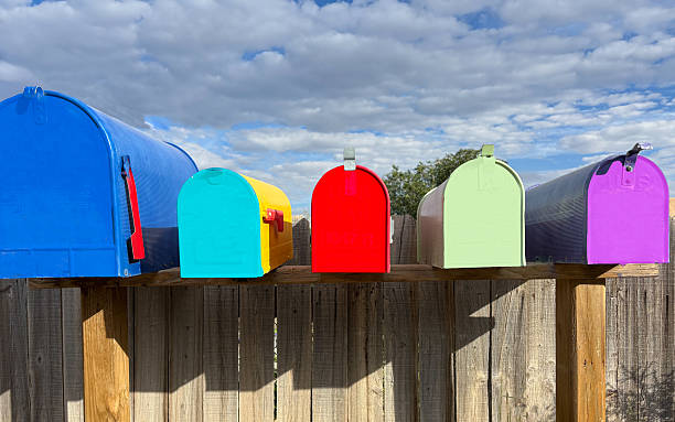 Row of Vibrant Classic Rural US Mailboxes, Sun and Clouds. Shot in Santa Fe, NM.