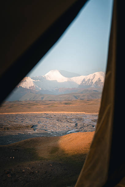 istock View through tent to lake and mountains at sunset 2233435721