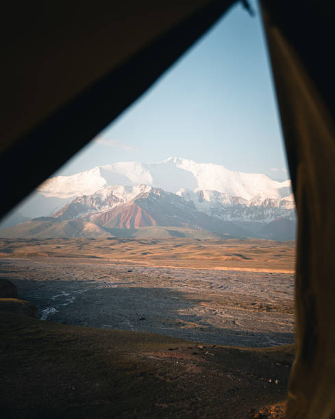 istock View through tent to lake and mountains at sunset 2233435724