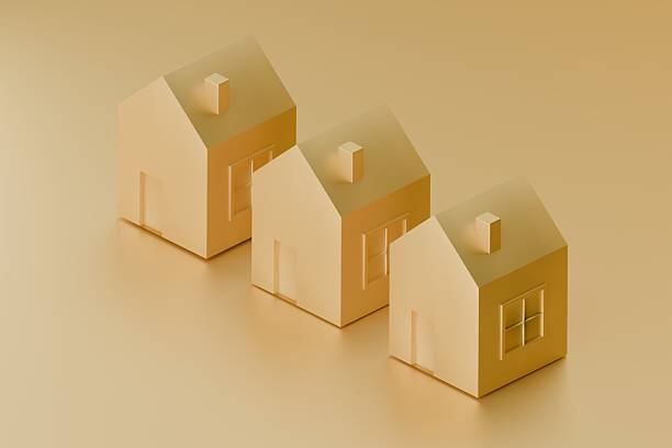 istock group of gold 3d houses on plain background 2233436243