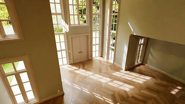 istock Sunlight illuminating empty room with parquet and tall windows 2233436375