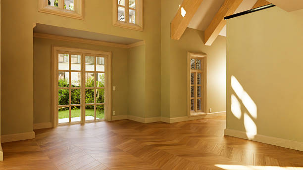 istock Sunlight illuminating empty room with parquet flooring and high ceiling 2233436408
