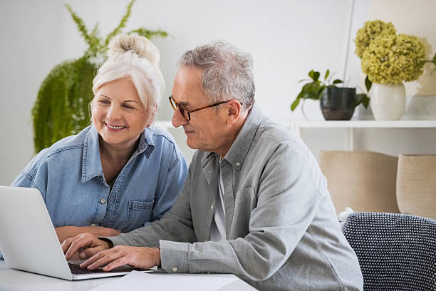 istock Senior couple using laptop at home 2233436979