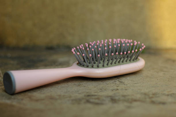 istock woman's hair comb isolated on cement floor 2233437091