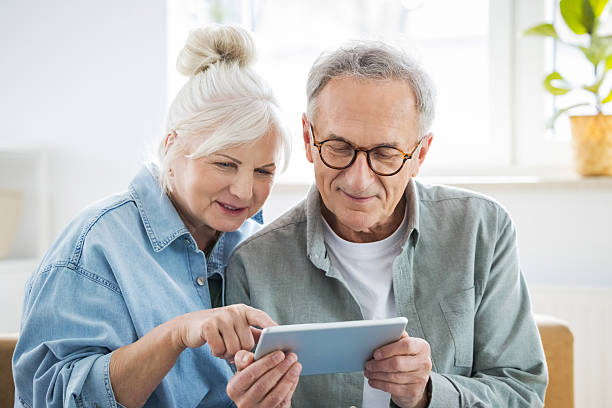 istock Happy senior couple using digital tablet at home 2233437121