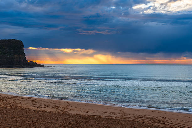 istock Winter sunrise by the sea shore with rain clouds 2233437166