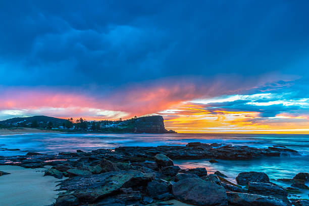 istock Winter sunrise by the sea shore with rain clouds 2233437207