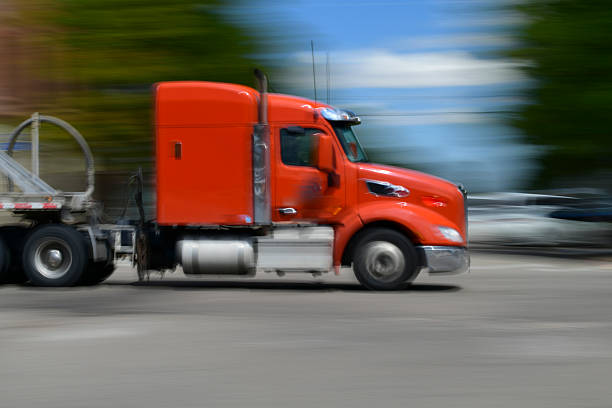 Walsenburg, Colorado USA- August 27, 2025  A Semi Truck rolls through town. A slow shutter was used to capture a sense of Motion. Copy space available.