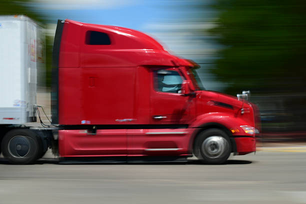 Walsenburg, Colorado USA- August 27, 2025  A Semi Truck rolls through town. A slow shutter was used to capture a sense of Motion. Copy space available.