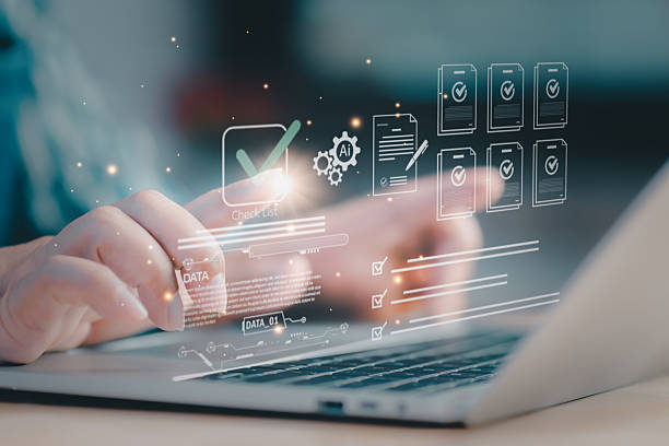 istock Concept of AI-driven checklist and document control professional types on laptop, with floating check marks and files, signaling compliance verification, approval workflow, and efficient operations. 2233440644