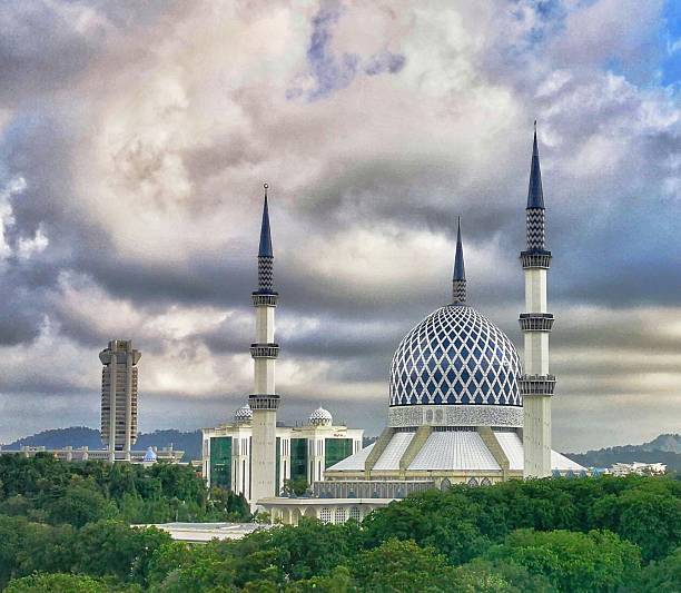 istock Majestic Mosque Against a Dramatic Cloudy Sky with Lush Green Surroundings 2233441720