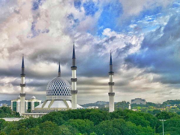 istock Magnificent Mosque Against Dramatic Sky with Lush Green Surroundings 2233441745