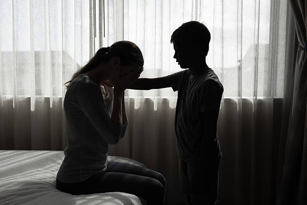 istock Little boy consoling comforting a distressed mother, next to window backdrop, concept of empathy, support, and close family  relationships. 2233442004