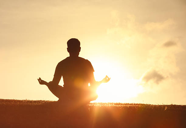 istock Man meditating early morning outdoors. 2233442057