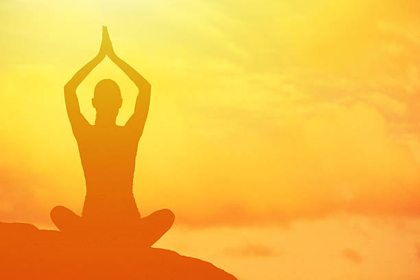 Yoga in Hampi temple copyspase at sunset.travel vacation copy spase lady with stylish jumpsuit
