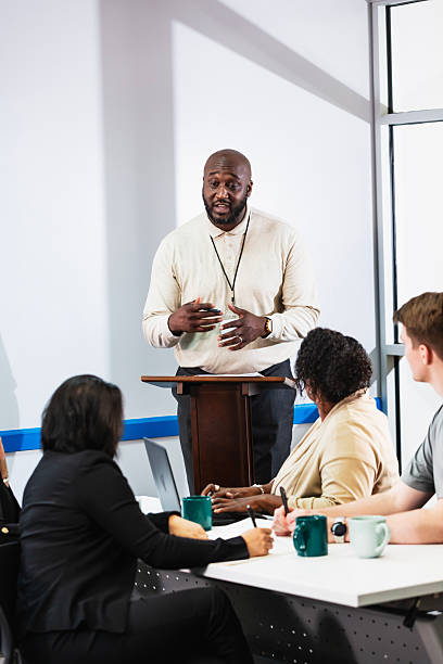 istock Mature black man at lectern giving presentation 2233442627