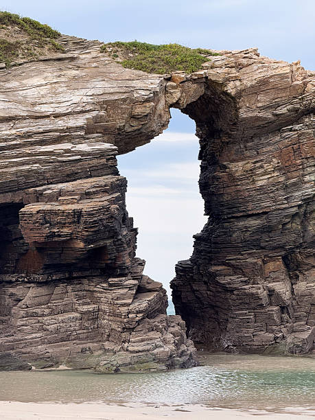 istock Natural rock arch in Playa de las Catedrales, Spain 2233442796
