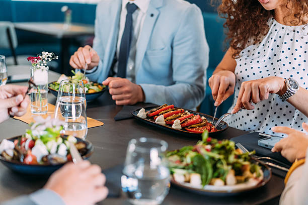 istock Businesspeople having lunch together. 2233444332