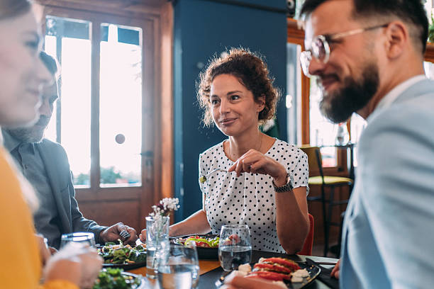 istock Happy business colleagues talking while eating lunch in a restaurant. 2233444377