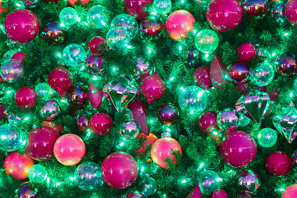 Close-up of a decorated christmas tree, full of colorful baubles and lights, creating a festive and joyful atmosphere