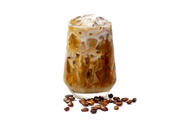 Latte ice coffee served with coffee beans spread around glass,isolate and white background.