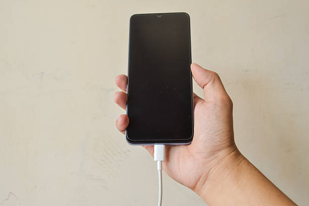 istock A man is charging the smartphone 2233446635