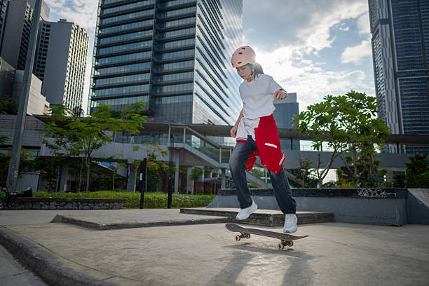 Skater woman confidently rides her skateboard on a skatepark ramp with the city's towering buildings providing a striking urban backdrop