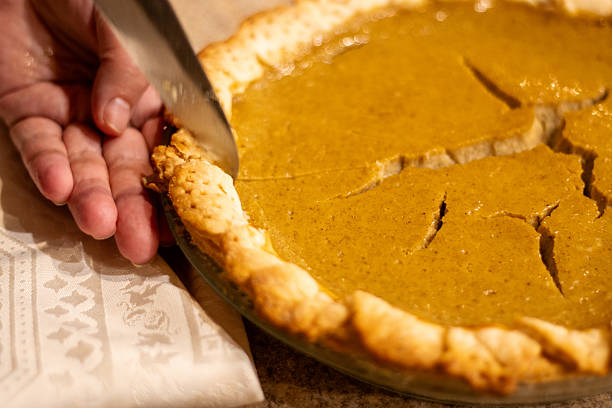 istock Pumpkin Pie Being Sliced in Warm Light 2233447642