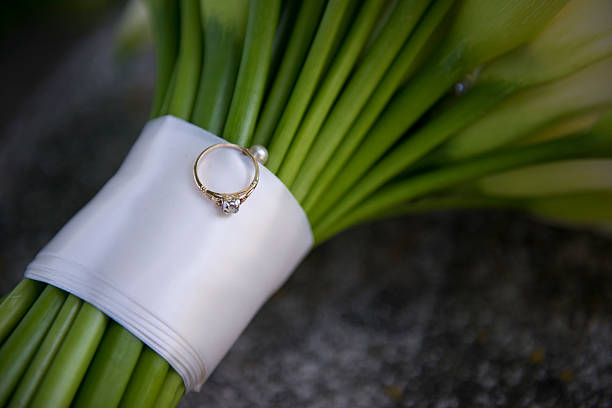 istock Heirloom Engagement Ring on Calla Lily Bridal Bouquet 2233448119