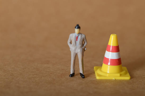 istock Corporate Oversight and Risk Management: Conceptual Image of a Manager and Warning Cone Representing Strategic Safety Planning. 2233452199