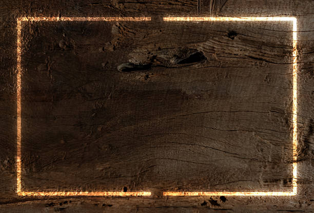 Rustic wooden background with rich dark brown texture main subject. Surface rough and weathered natural grains and knots. Superimposed on background glowing orange-yellow rectangular frame