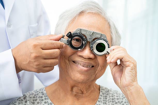 istock Asian senior woman wearing ophthalmic vision eye test and using optical trial frame. 2233458996