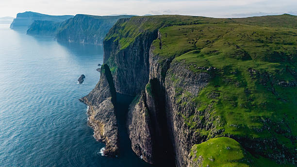 istock Majestic cliffs of the Faroe Islands overlooking tranquil waters at sunset 2233462675