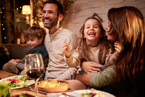 istock Happy family having fun during lunch in dining room. 2233465517