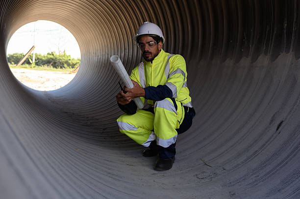 istock A male mechanical engineer in safety uniform is inspecting and examining a piping system for a new construction project of a large industrial building. 2233465790