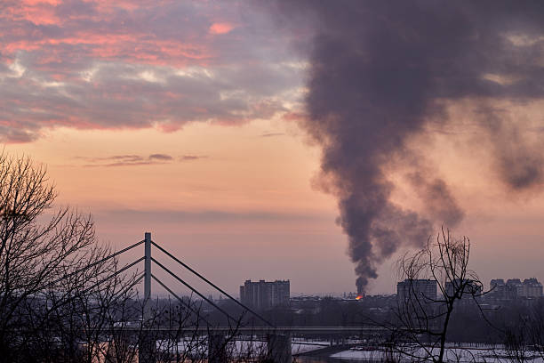 View on the burning building in the city at sunset.