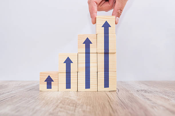 istock Hand arranging wood block stacking as step stair with arrow up. Ladder career path concept for business growth success process 2233466406