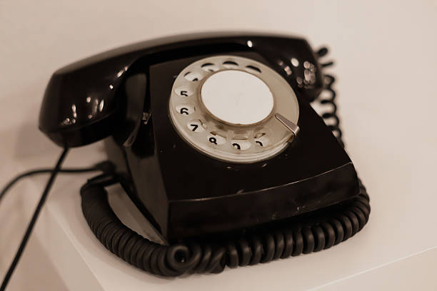 istock A vintage rotary telephone rests on a clean, minimalist table against a neutral backdrop. The device highlights the charm of old-school communication methods in a contemporary setting 2233469862