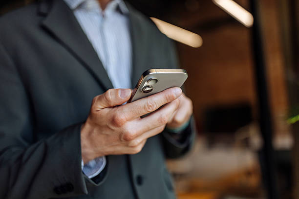 istock Close-up of a Business Professional Using a Smartphone in an Office Space 2233469996
